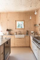 Butler sink in modern timber clad country kitchen 