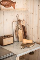 Selection of wooden chopping boards and small Marshall amp on kitchen worktop 