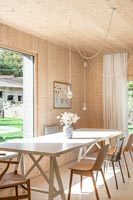 Modern timber clad dining room with garden views 