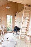 Modern timber clad children's room with ladder to mezzanine 