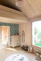 Timber clad children's room with view of mezzanine 