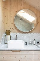 Modern bathroom sink with patterned splashback tiling 