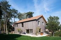 Modern timber clad country house with garden 