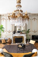 Large gilded chandelier in centre of classic living room 