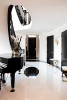 Grand piano in black and white hallway 