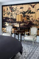 Chinese artwork - feature wall in bedroom with seating area 