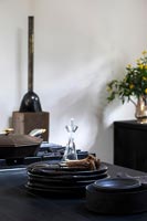 Modern cottage style dining room with dark coloured crockery