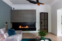 Modern living room with lit fireplace 