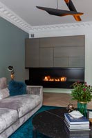 Modern living room with lit fireplace 