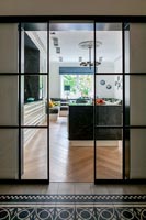 Sliding internal doors with view into modern kitchen 