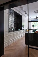 View into large modern kitchen with period details - parquet floor and original cornicing 