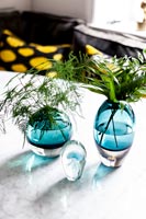 Turquoise vases with foliage cuttings 