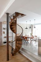 Modern dining room with spiral staircase 