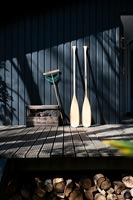 Set of oars leaning against a black painted wooden cabin 