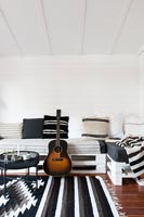 Acoustic guitar in modern black and white living room 
