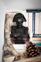 Bust statue on piles of books 