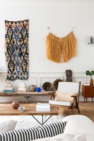 Fabric wall hangings on modern living room wall 
