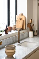 Grey marble worktop and sink in modern kitchen 
