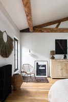 Exposed wooden beams in modern bedroom 