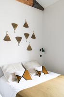 Decorative wall display in modern brown and white bedroom 