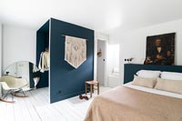 Modern bedroom with blue feature wall of wardrobe 