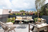 Seating area on decked modern roof terrace garden 