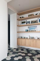Patterned floor and modern built-in sideboard and shelving 
