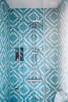 Blue and white patterned tiling in shower cubicle 