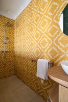 Yellow patterned tiling in modern shower room 