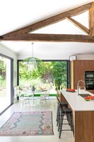 Exposed wooden beams over modern kitchen diner 