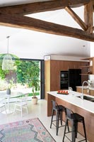 Modern kitchen-diner with exposed wooden beams 