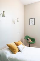 Green chair with toys in modern childrens bedroom 