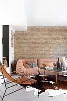 Exposed stone wall in modern living room 