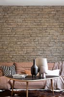 Exposed stone wall in modern living room 