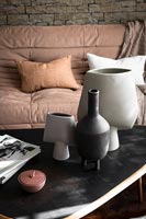 Collection of ceramic pots and vases on coffee table 