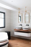 Black and white double sinks in contemporary bathroom 