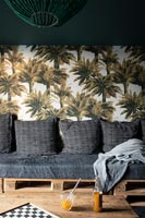 Palm tree patterned wallpaper feature wall in grey living room 