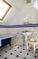 Classic bathroom with decorative tiling and freestanding bath