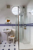 Classic bathroom with decorative tiling and shower cubicle 