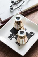 Opera glasses on small plate with binocular detail 