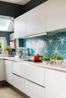Teal and white patterned tiling in contemporary kitchen 