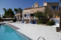 Stone country house with modern swimming pool, decking and recliners 
