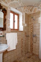 Exposed stone wall in country bathroom 