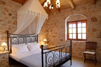 Exposed stone walls in country bedroom 