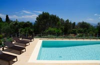 Recliners next to swimming pool with countryside views 