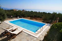 Overview of swimming pool with recliners and scenic views 