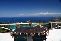 Outdoor dining table on terrace with coastal views 