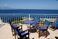 Blue furniture on terrace overlooking the sea 