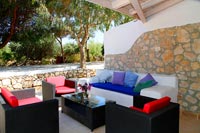Outdoor living area with built-in whitewashed sofa 