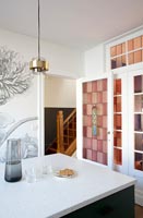 Pink tiled wall and mural in modern kitchen 